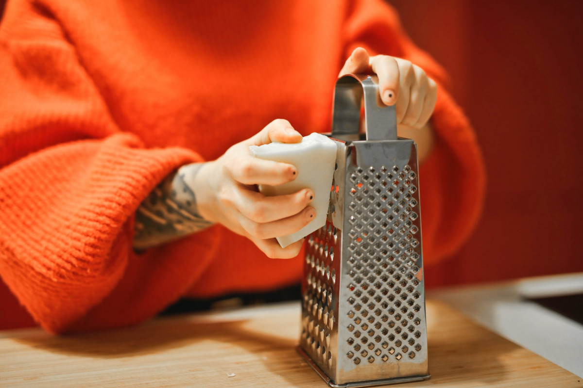 person holding grater