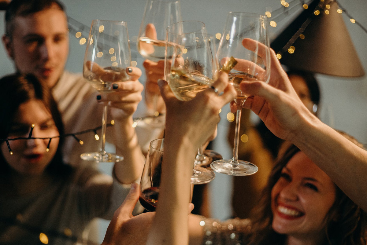 selective focus photography of several people cheering wine glasses